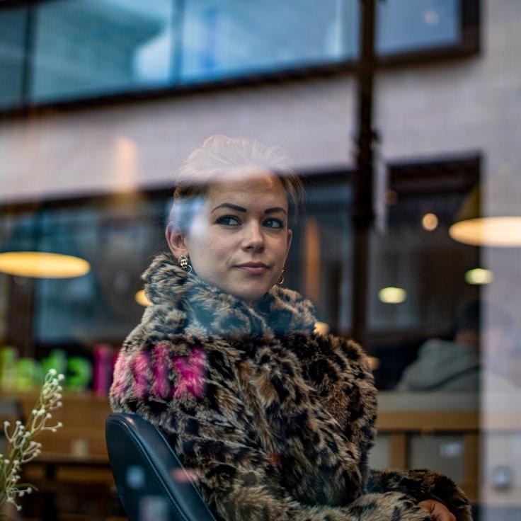 Avery Chen, Lead Design Curator at NimbusStellarAxis, reviewing corporate floral arrangements